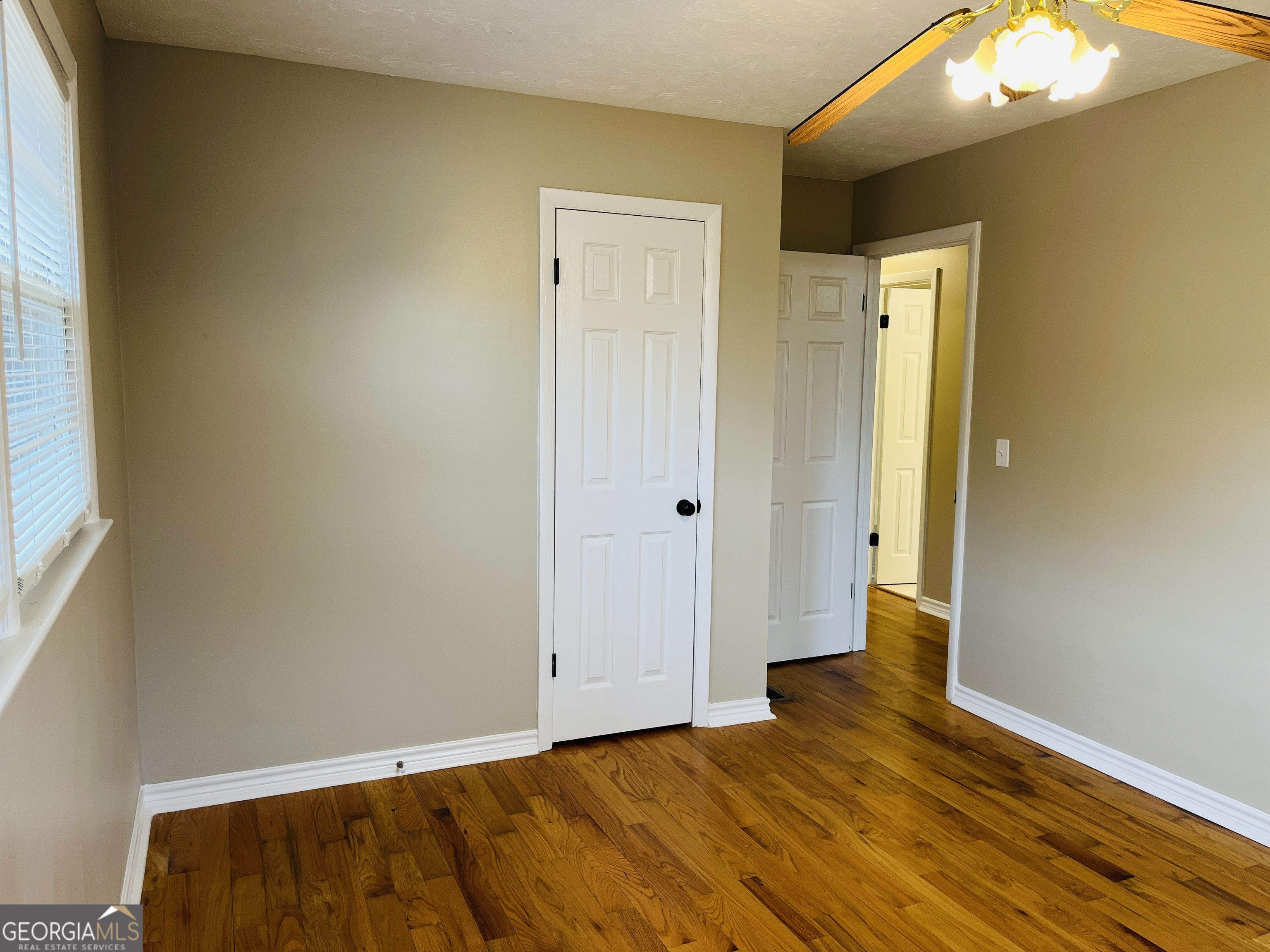 1085 Horsley Mill Road Carrollton, GA 30116 - Photo 18 of 26 a view of an empty room with wooden floor and a window