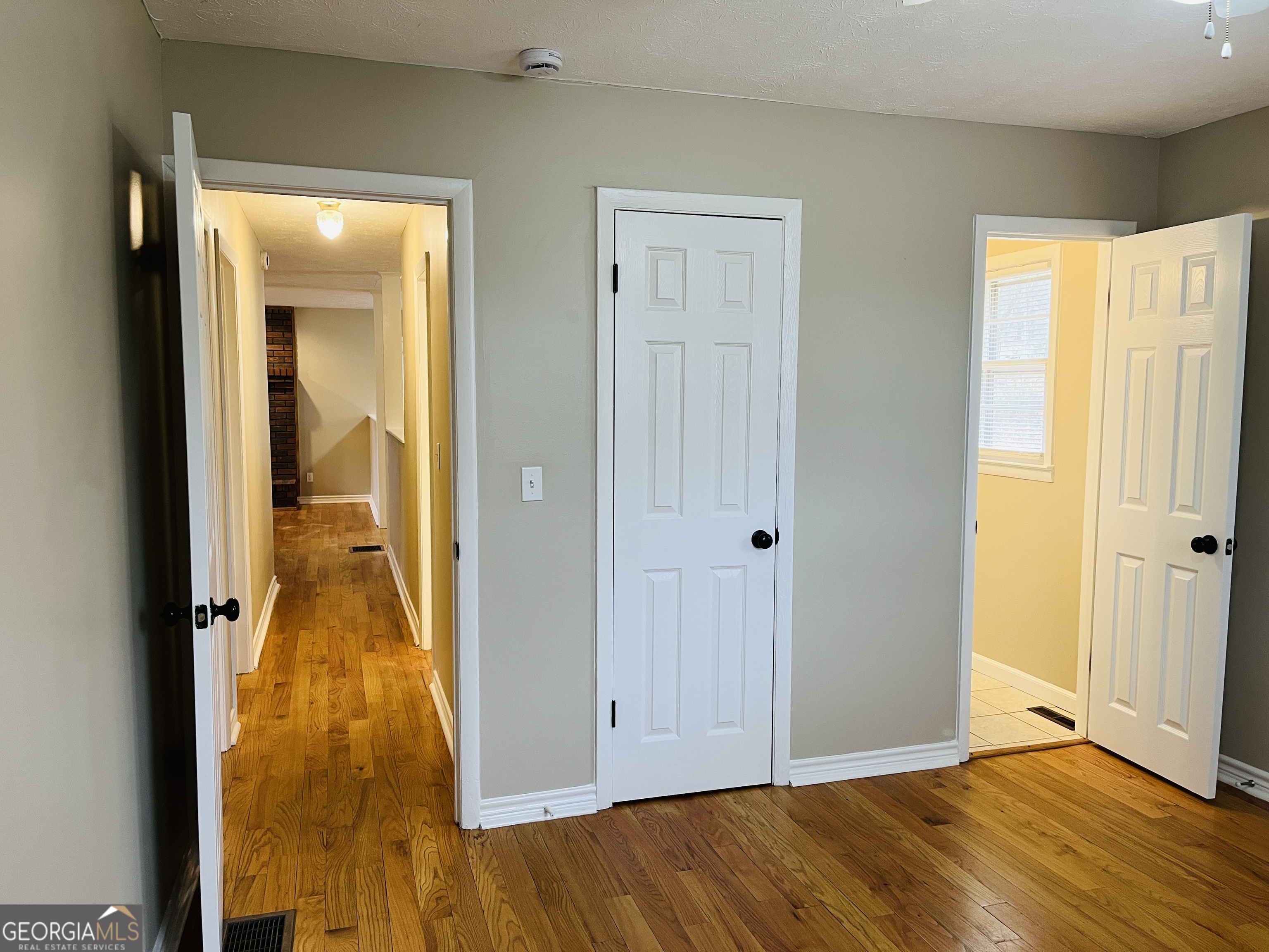1085 Horsley Mill Road Carrollton, GA 30116 - Photo 20 of 26 a view of a hallway with wooden floor and a bathroom