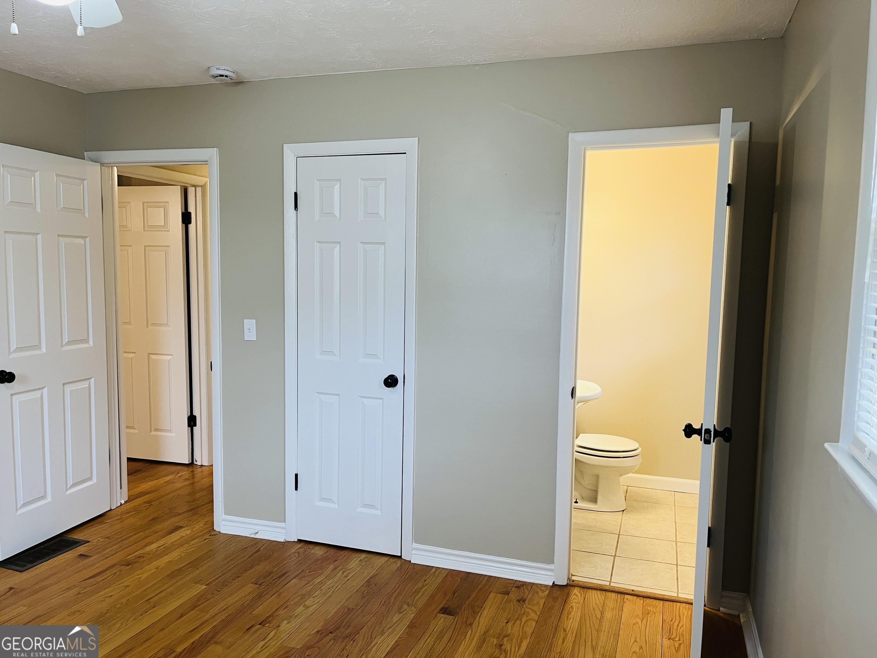 1085 Horsley Mill Road Carrollton, GA 30116 - Photo 21 of 26 a view of a bathroom with a toilet and a hardwood
