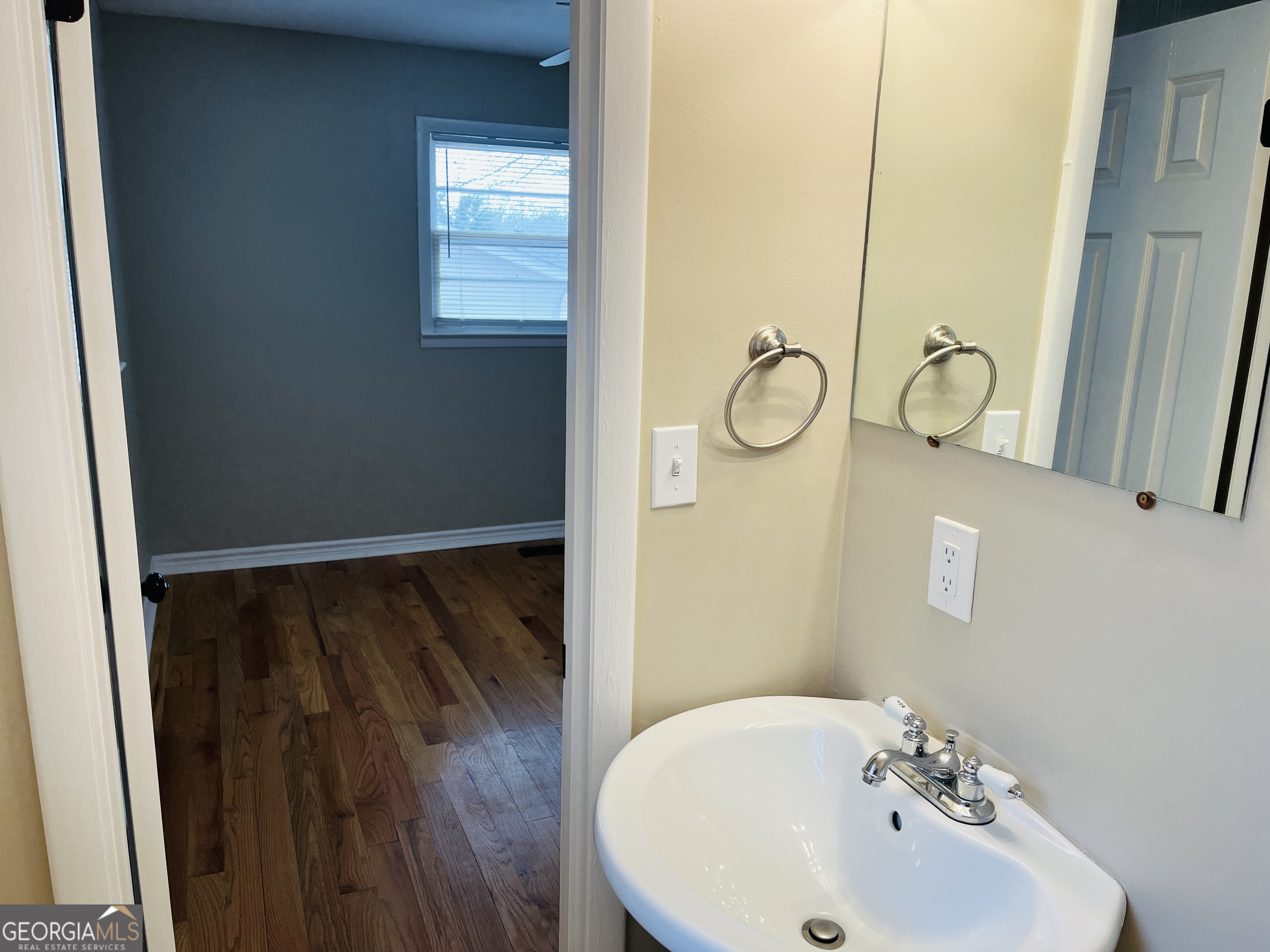 1085 Horsley Mill Road Carrollton, GA 30116 - Photo 23 of 26 a bathroom with a sink and mirror with bathtub