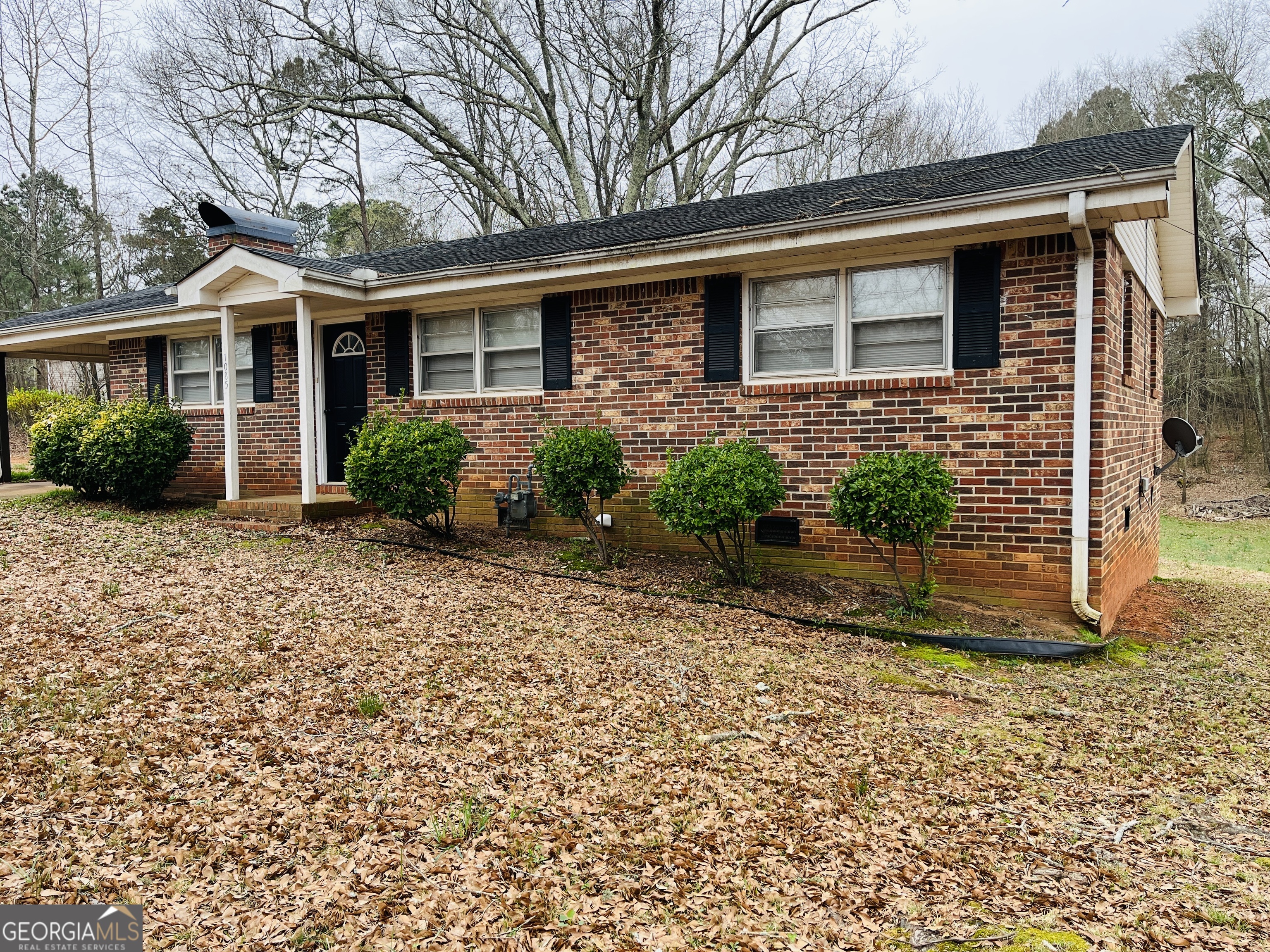 1085 Horsley Mill Road Carrollton, GA 30116 - Photo 25 of 26 a front view of a house with garden