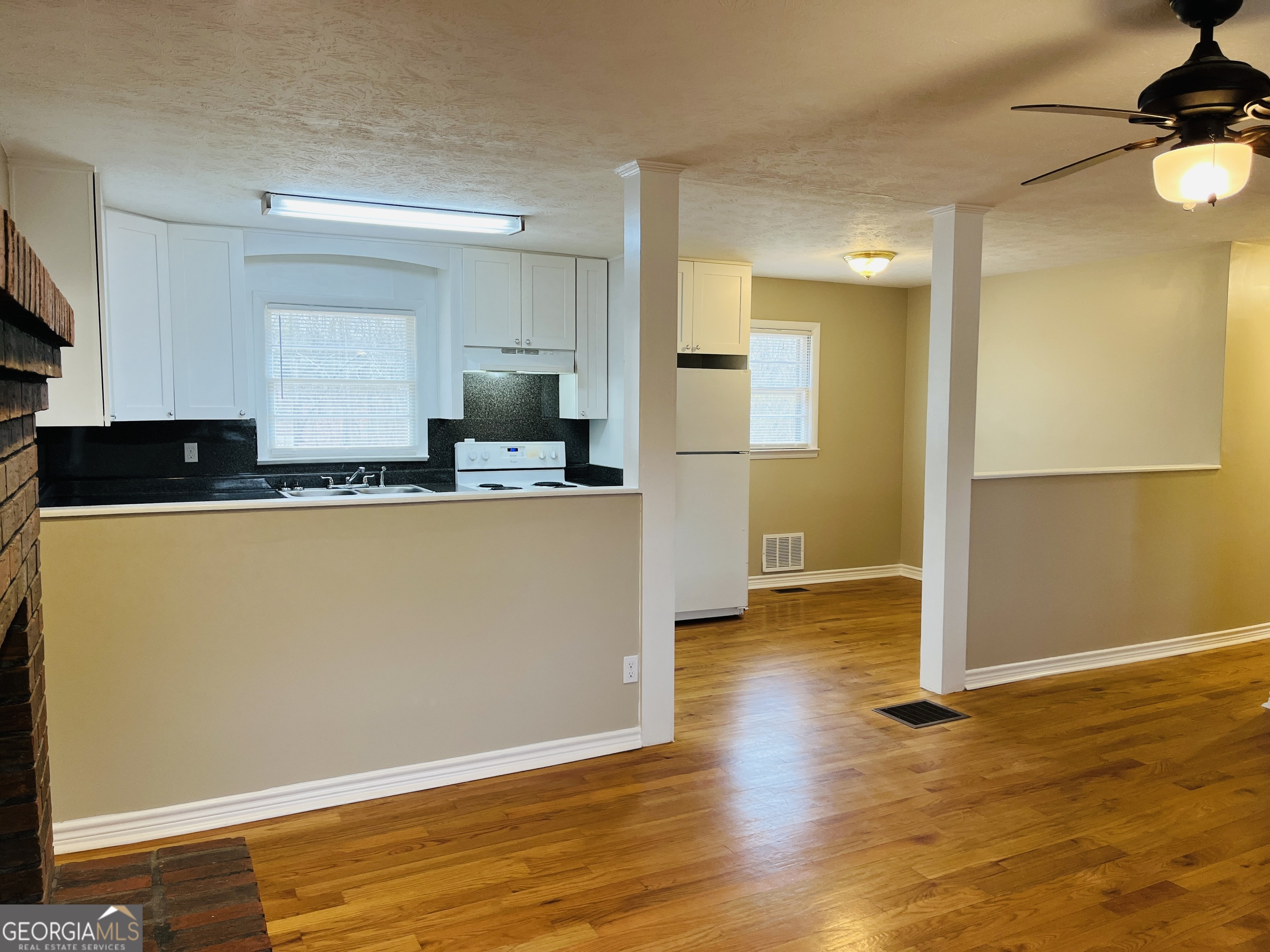 1085 Horsley Mill Road Carrollton, GA 30116 - Photo 6 of 26 a kitchen with stainless steel appliances granite countertop a refrigerator a sink and a stove