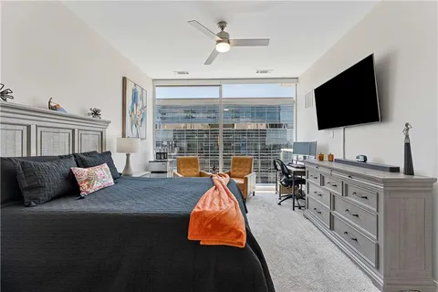 a bedroom with furniture and a flat screen tv