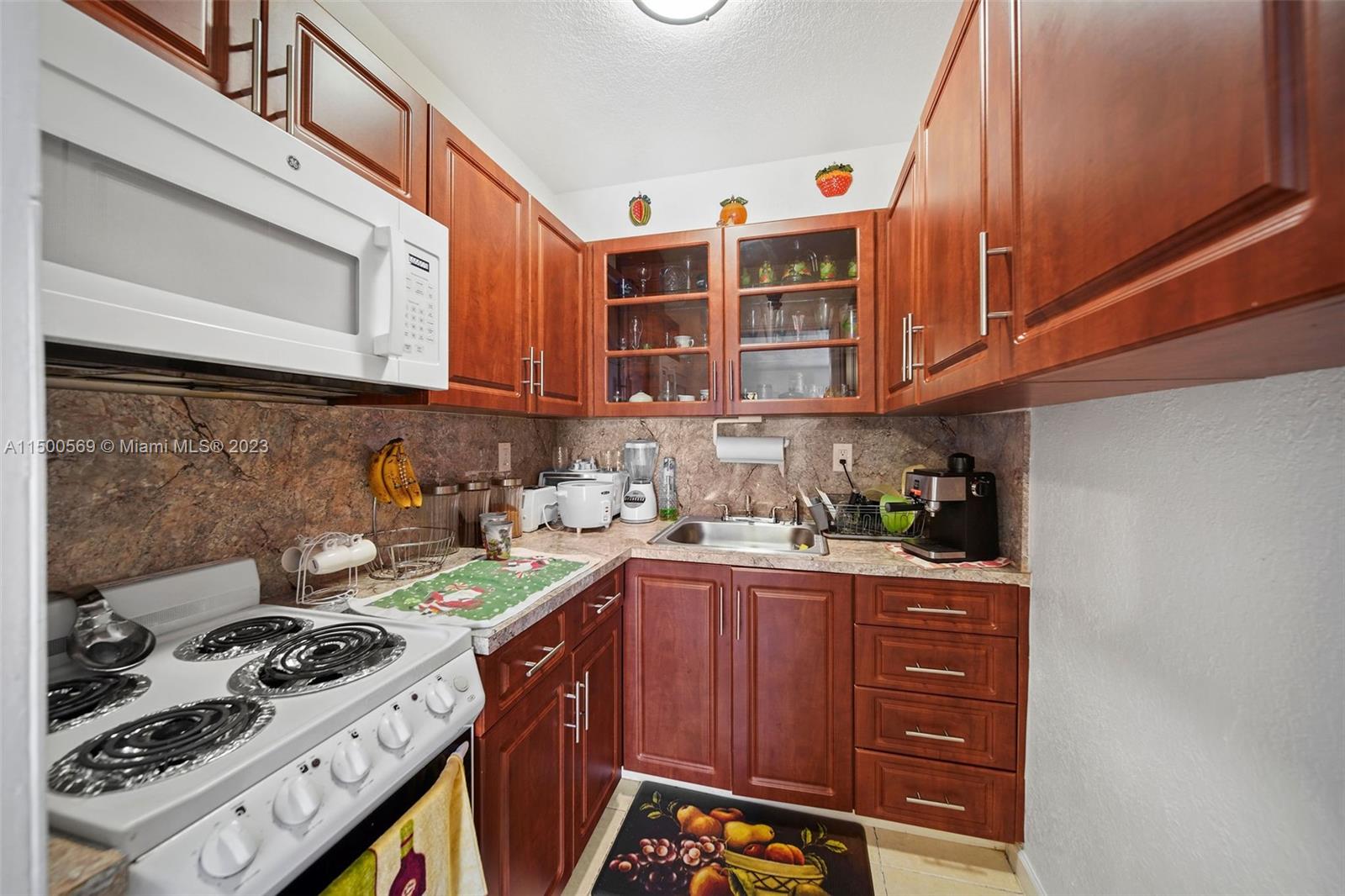 1828 Southwest 6th Street Miami, FL 33135 - Photo 18 of 50 a kitchen with granite countertop a stove and a sink