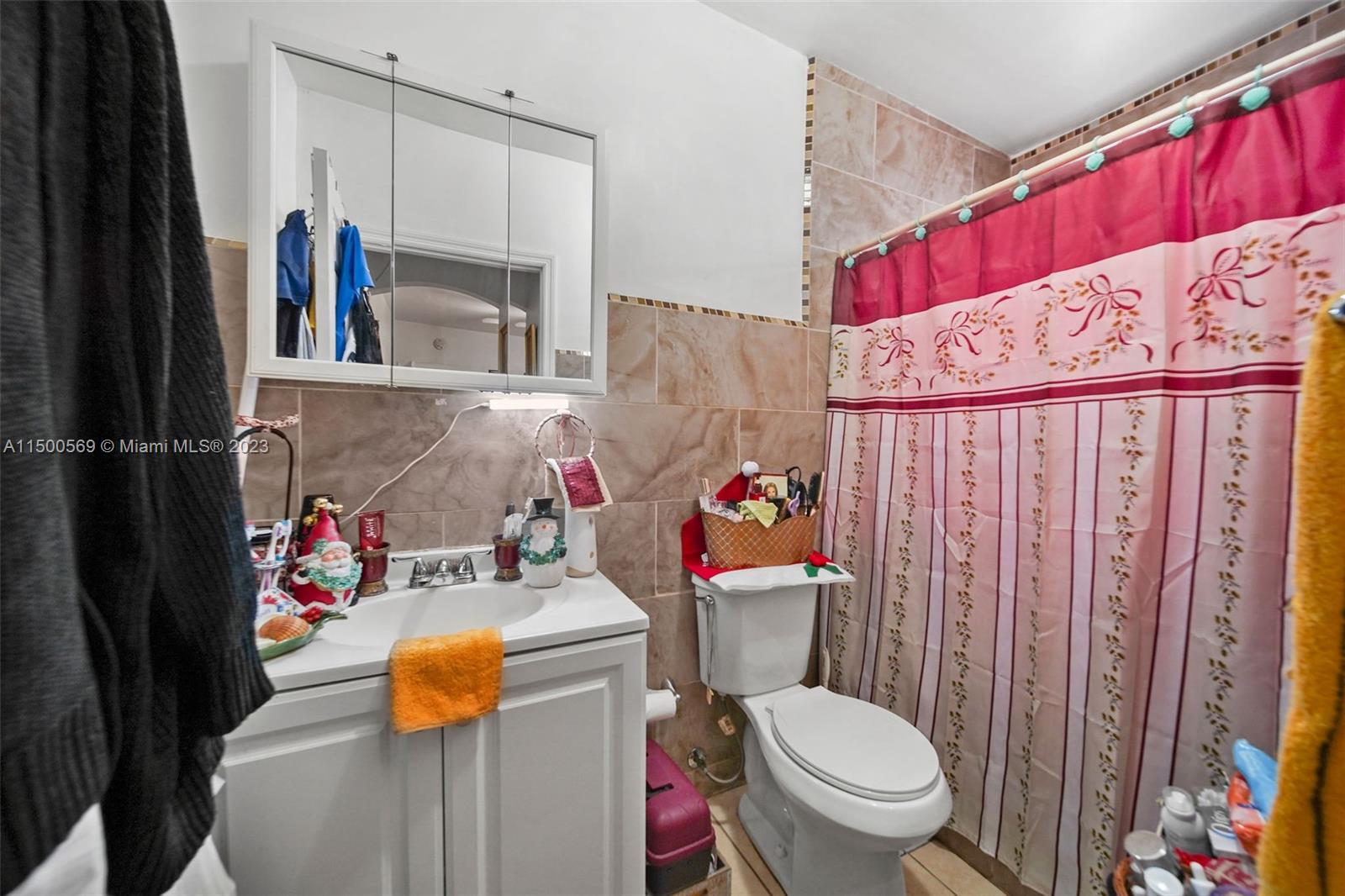 1828 Southwest 6th Street Miami, FL 33135 - Photo 26 of 50 a bathroom with a toilet and shower curtain