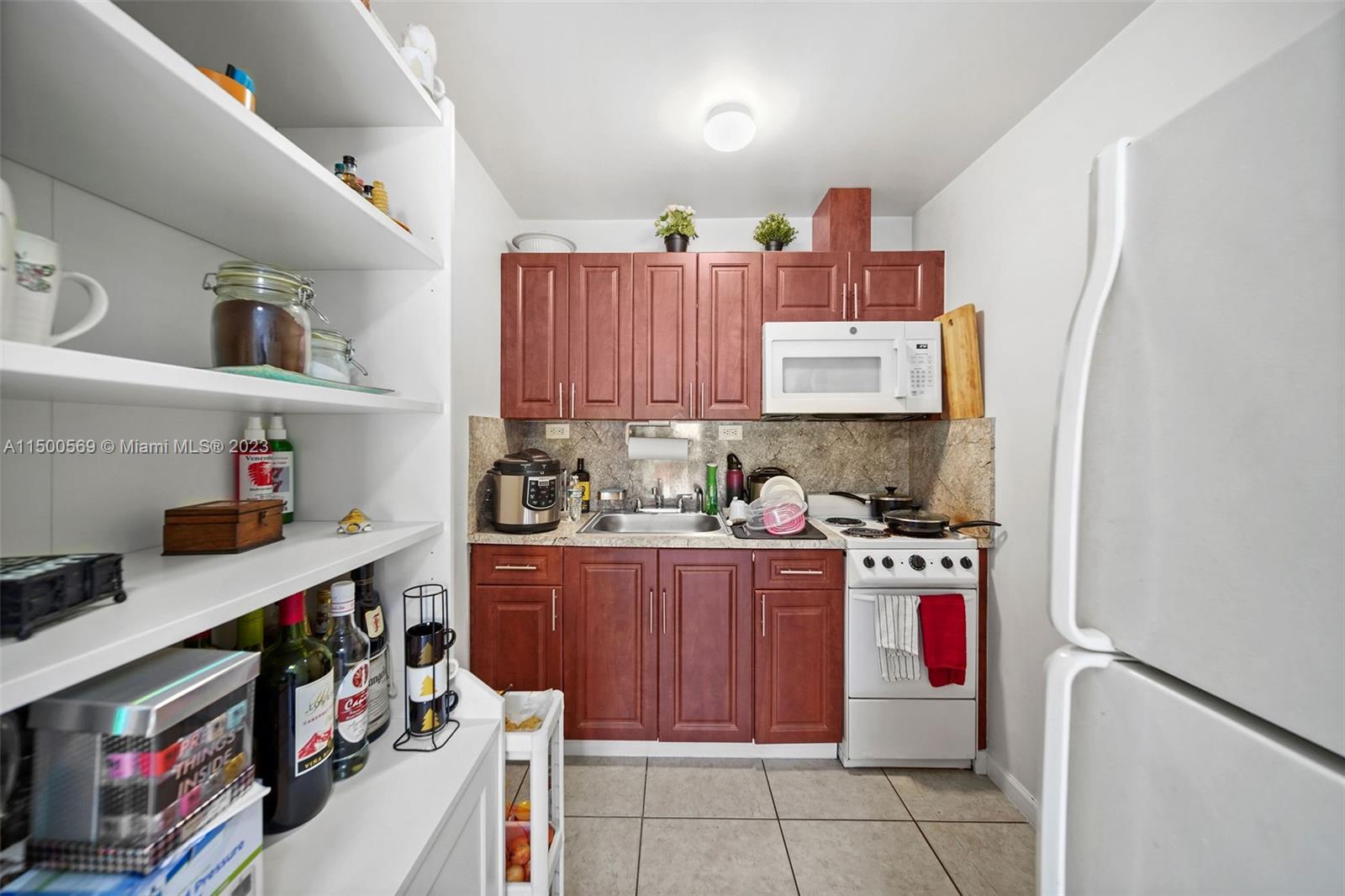 1828 Southwest 6th Street Miami, FL 33135 - Photo 34 of 50 a kitchen with stainless steel appliances a stove a refrigerator and cabinets