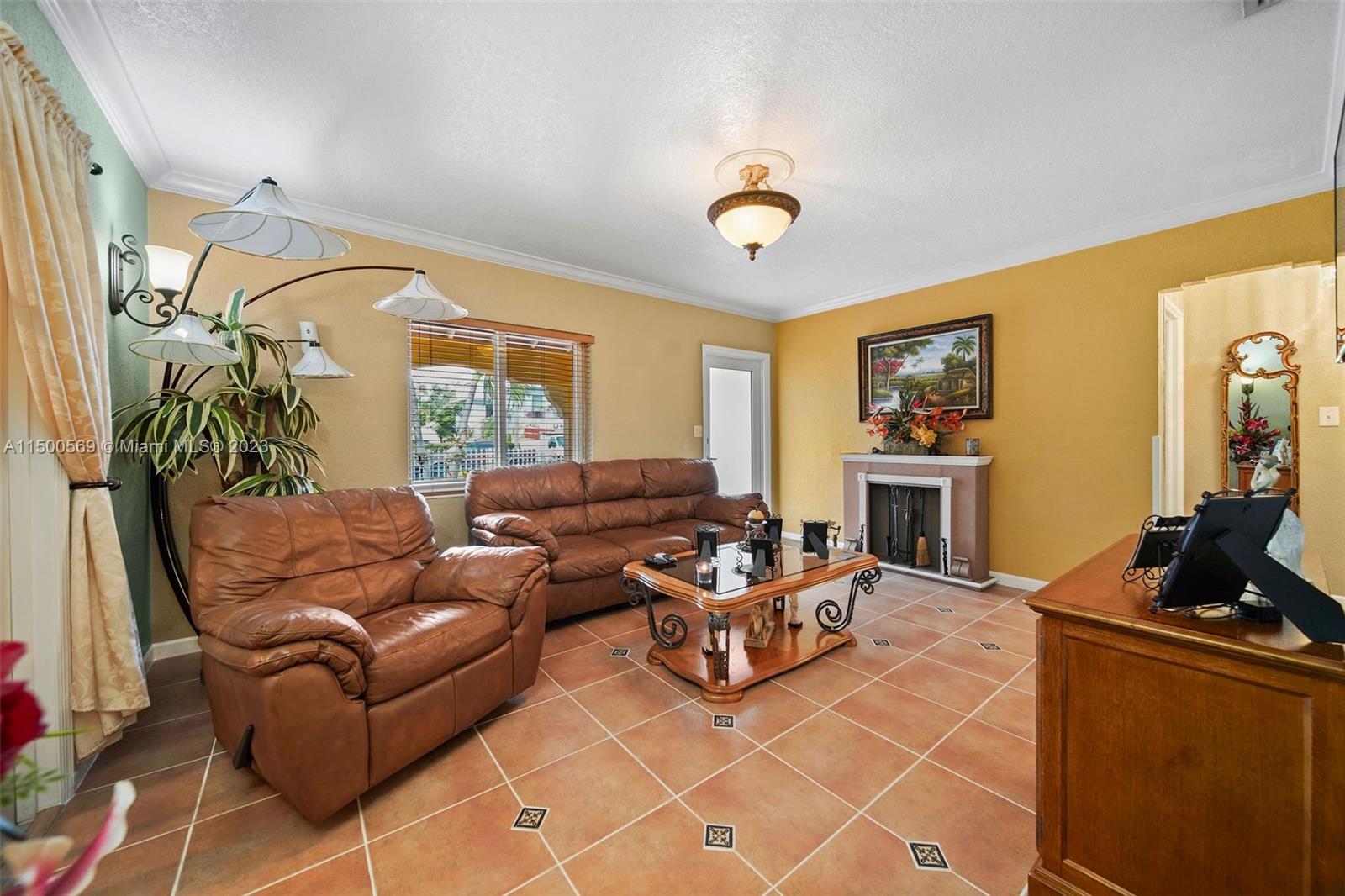 1828 Southwest 6th Street Miami, FL 33135 - Photo 5 of 50 a living room with furniture a flat screen tv and a fireplace