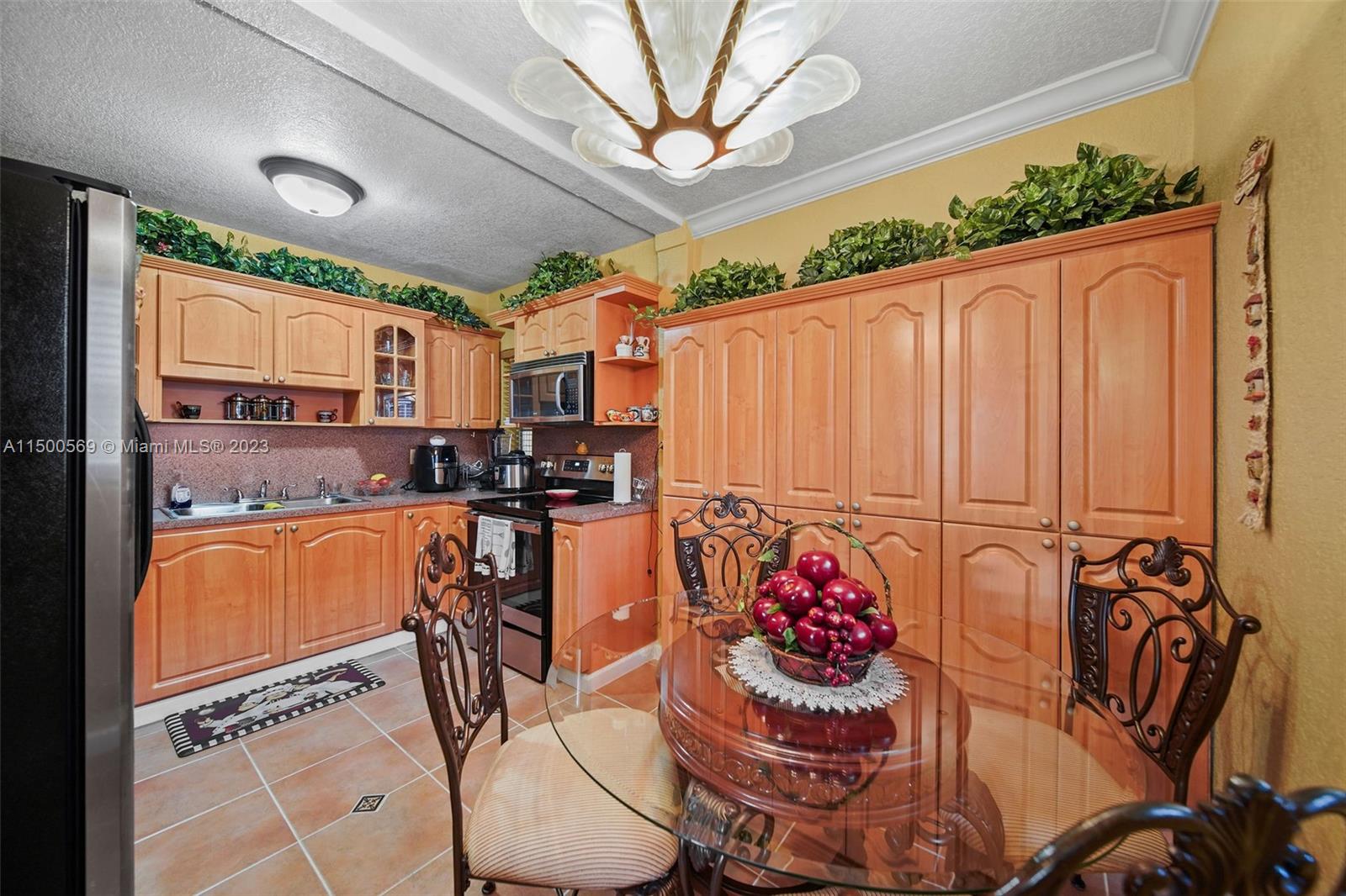 1828 Southwest 6th Street Miami, FL 33135 - Photo 7 of 50 a kitchen with stainless steel appliances kitchen island granite countertop a refrigerator and a stove top oven