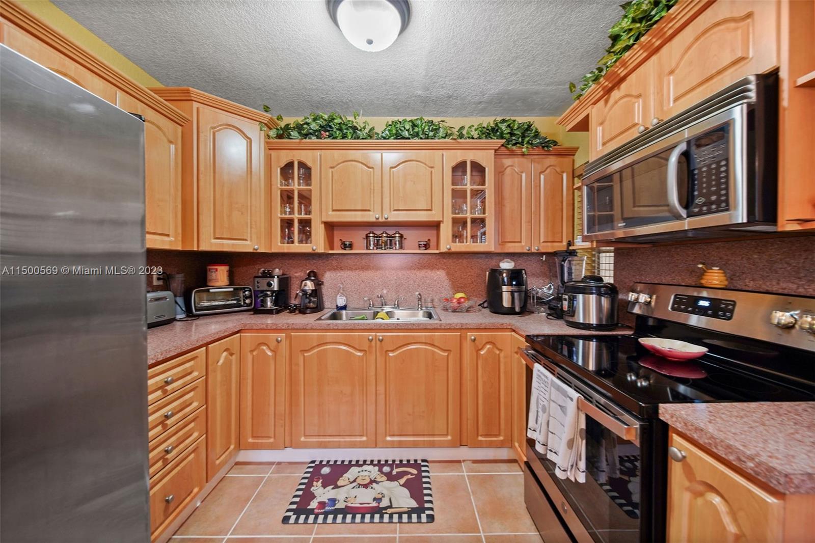1828 Southwest 6th Street Miami, FL 33135 - Photo 8 of 50 a kitchen with stainless steel appliances granite countertop a stove a sink and a microwave