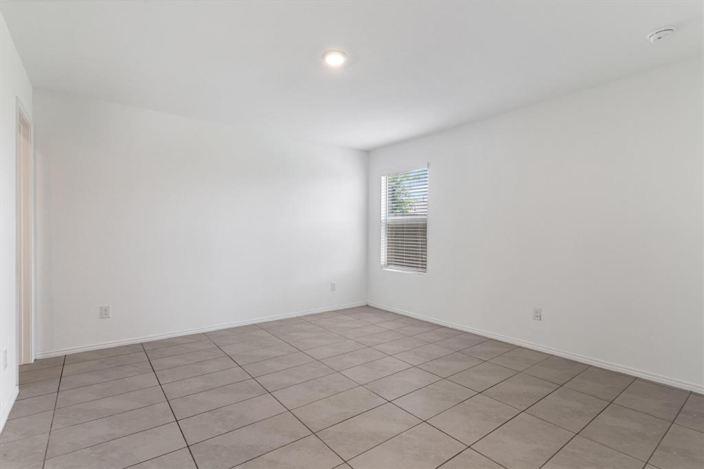 7781 Ruellia Road McKinney, TX 75071 - Photo 12 of 25 Unfurnished room with light tile patterned floors