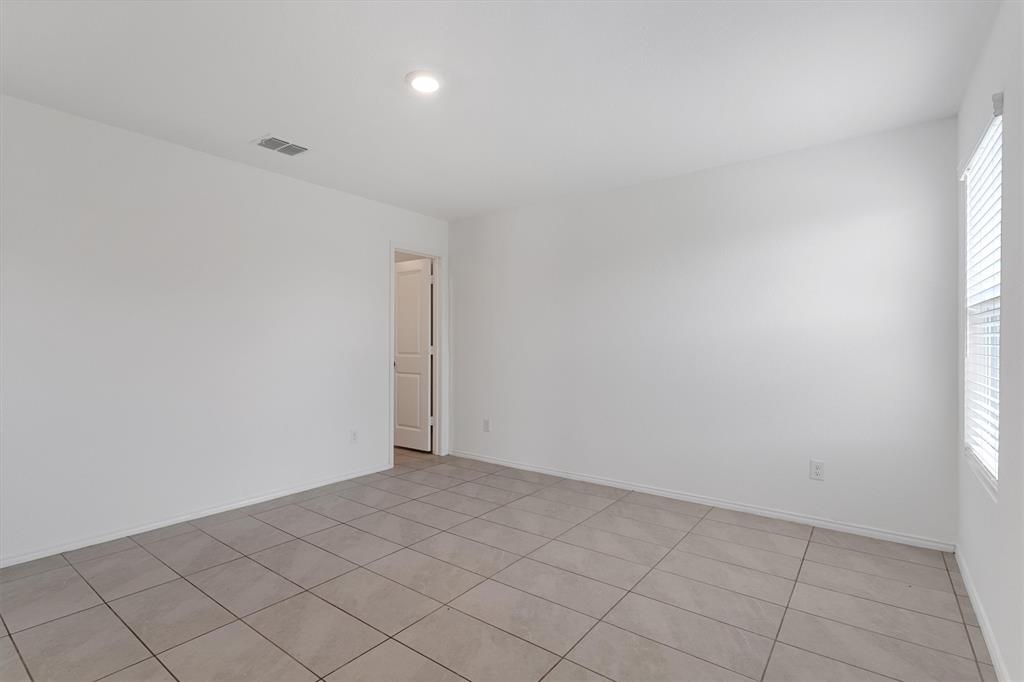 7781 Ruellia Road McKinney, TX 75071 - Photo 13 of 25 Spare room featuring light tile patterned floors and baseboards