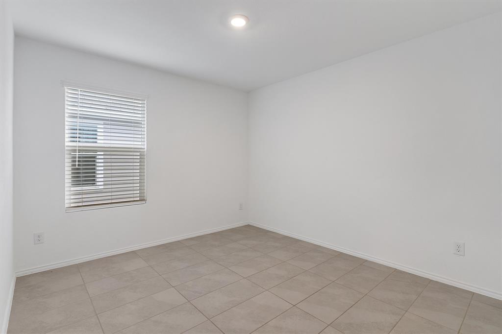 7781 Ruellia Road McKinney, TX 75071 - Photo 17 of 25 Empty room with baseboards