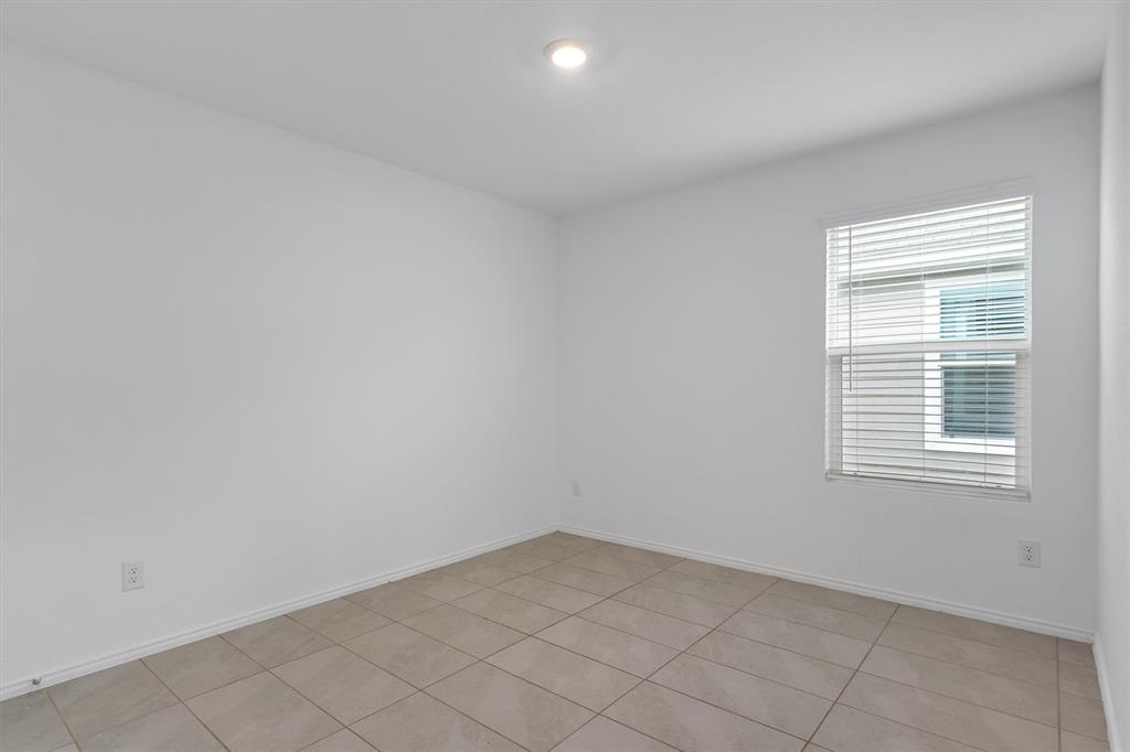 7781 Ruellia Road McKinney, TX 75071 - Photo 19 of 25 Empty room featuring baseboards and light tile patterned floors