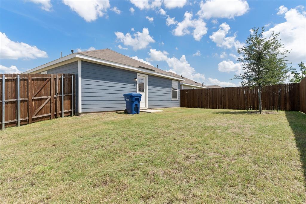 7781 Ruellia Road McKinney, TX 75071 - Photo 22 of 25 Rear view of house featuring a fenced backyard and a gate