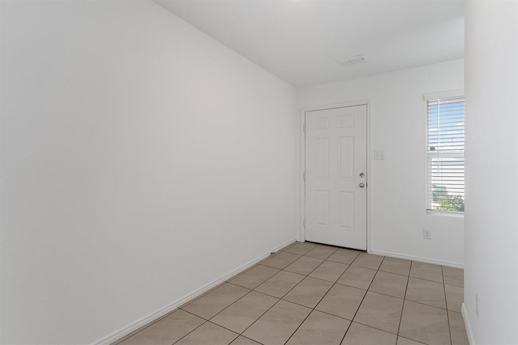 7781 Ruellia Road McKinney, TX 75071 - Photo 4 of 25 Unfurnished room featuring baseboards and light tile patterned flooring