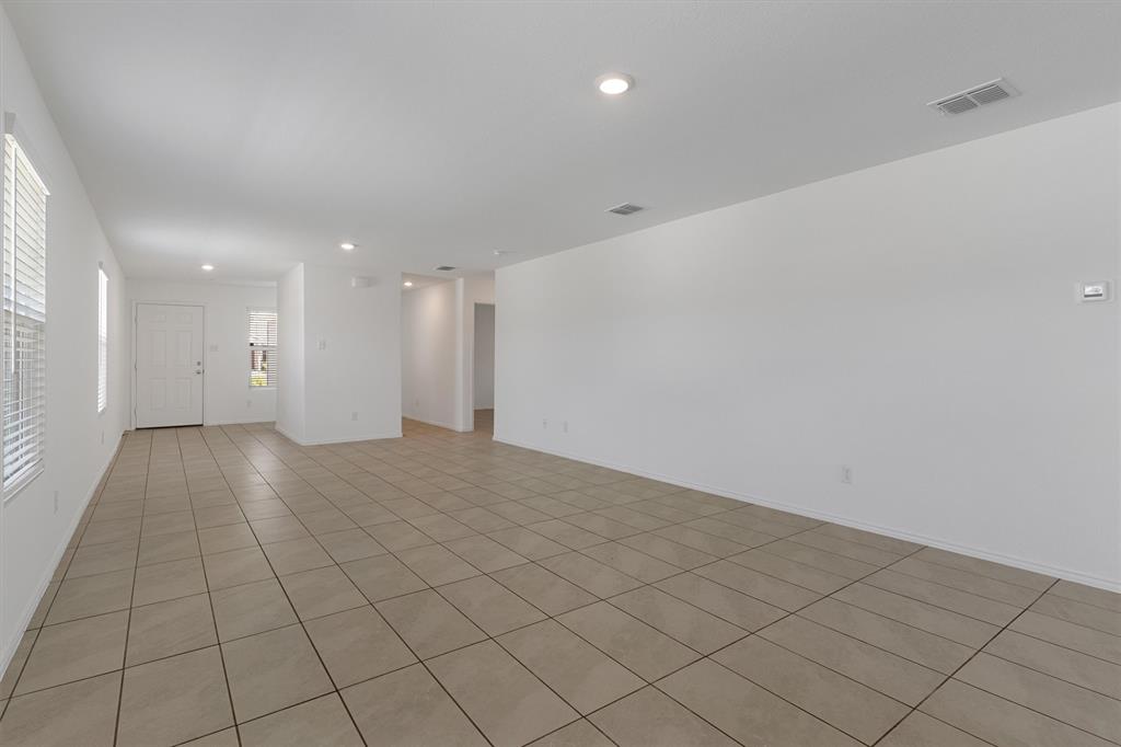 7781 Ruellia Road McKinney, TX 75071 - Photo 8 of 25 Empty room featuring light tile patterned floors and recessed lighting