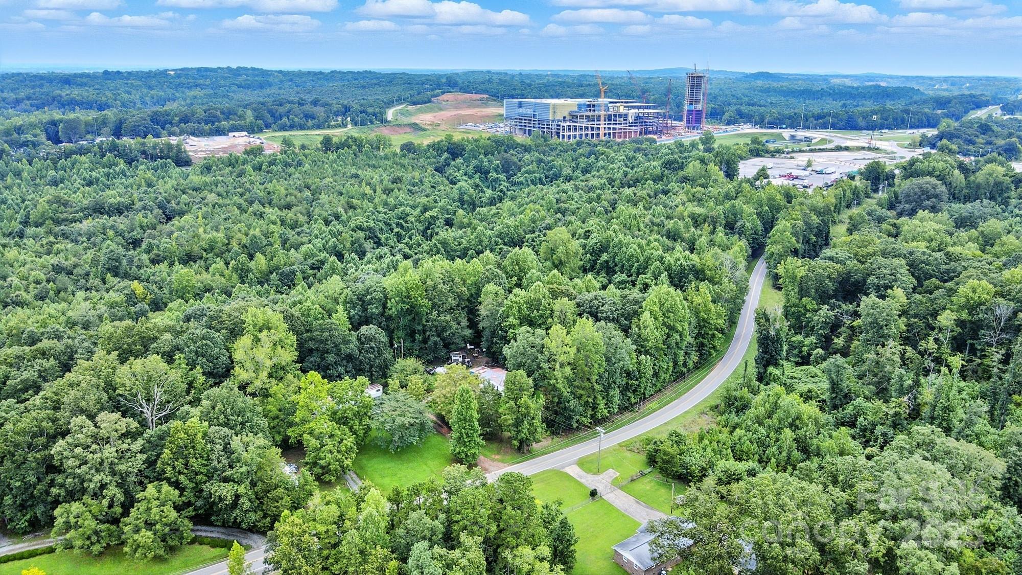 an aerial view of a house with a yard and lake view