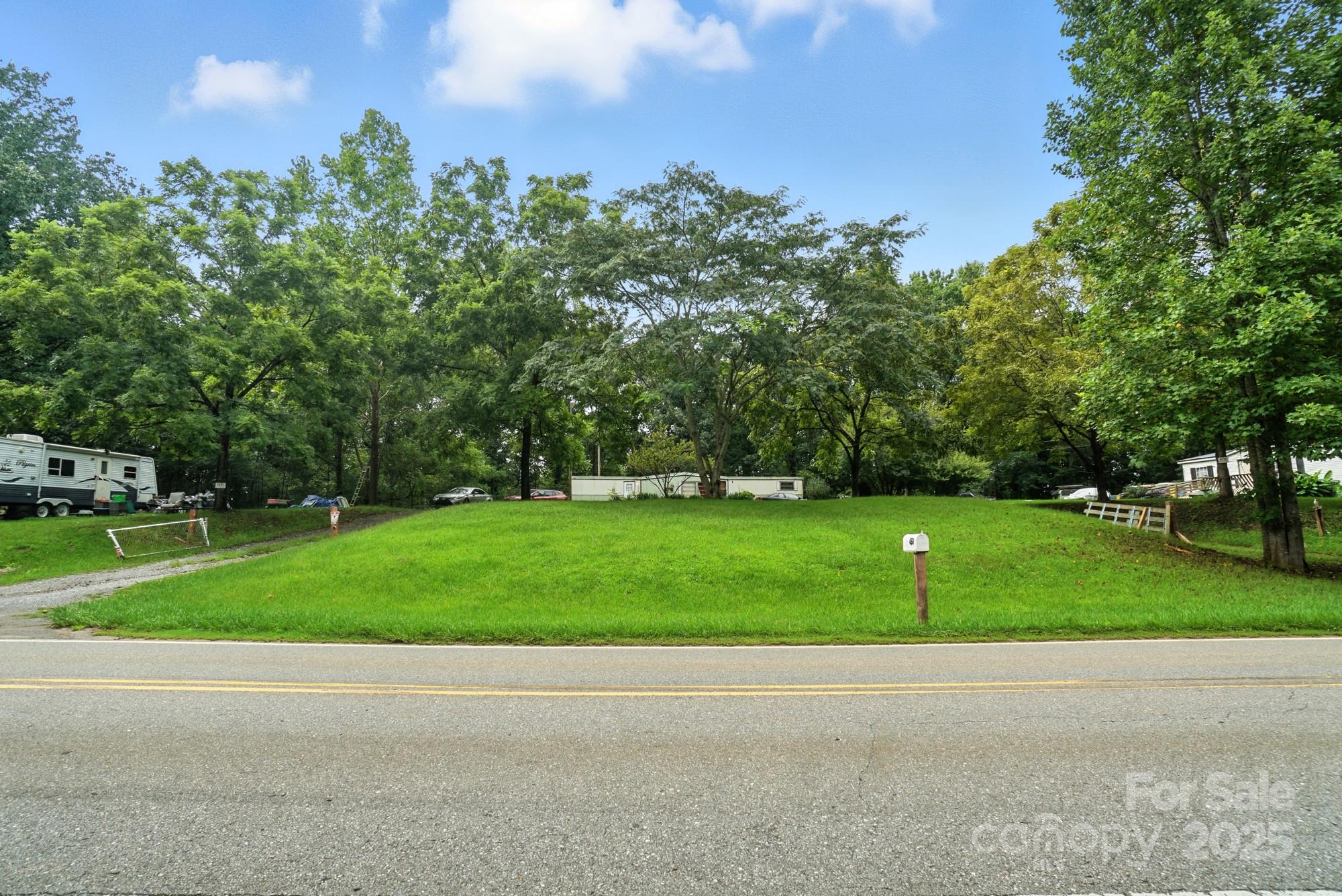 450 Dixon School Road Kings Mountain, NC 28086 - Photo 12 of 22 a green field with lots of trees in the background