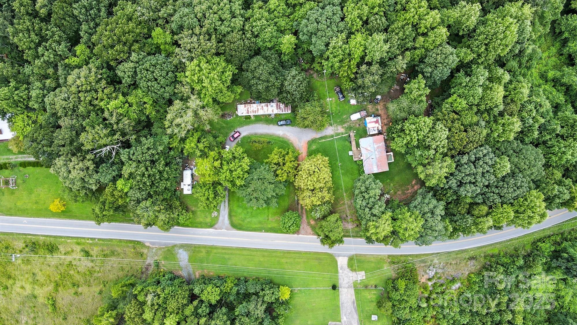450 Dixon School Road Kings Mountain, NC 28086 - Photo 5 of 22 a view of a yard with plants and large trees