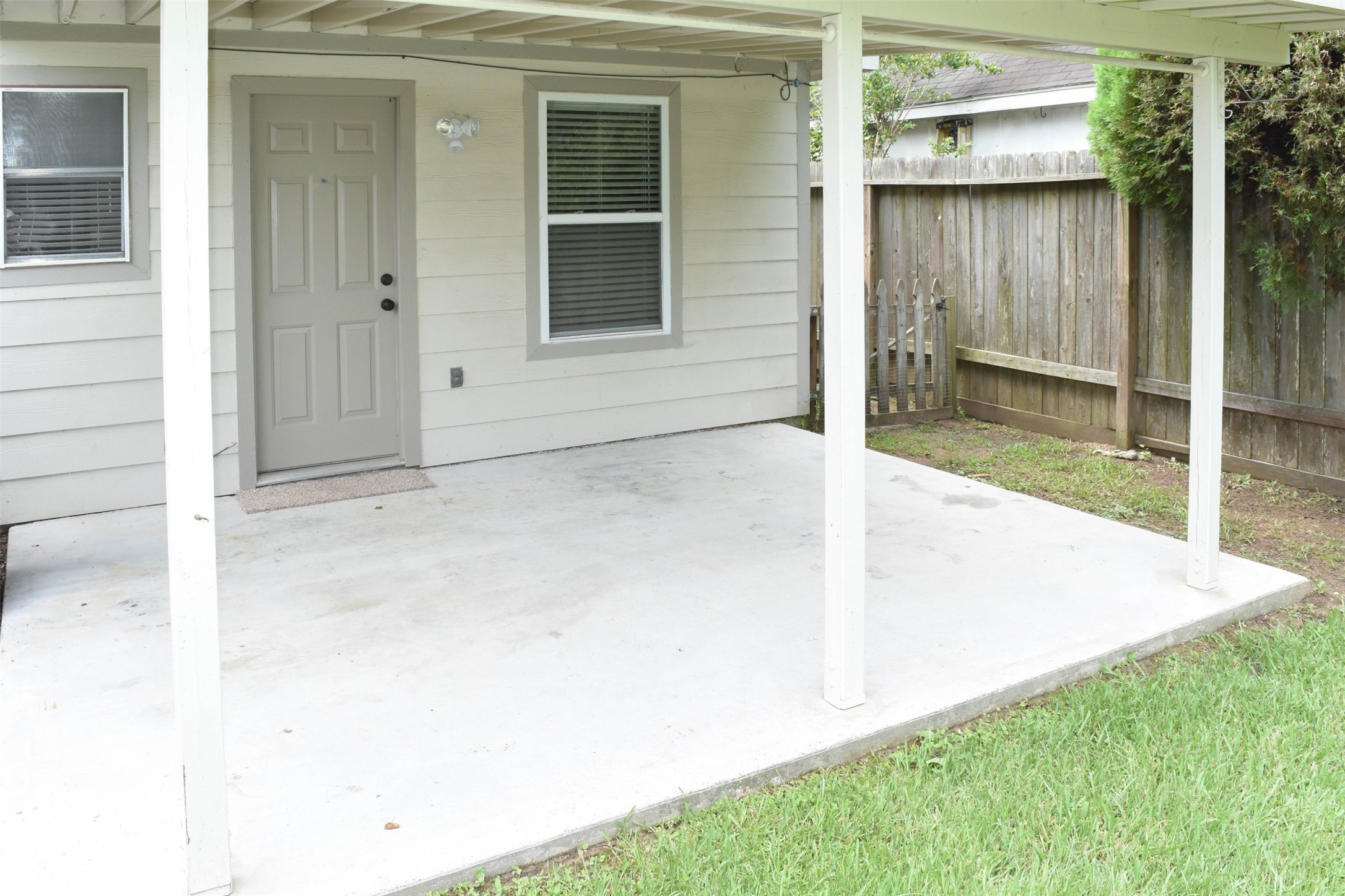 518 Moore Street Tomball, TX 77375 - Photo 16 of 18 Covered back patio provides shade and rain protection for outdoor activities.