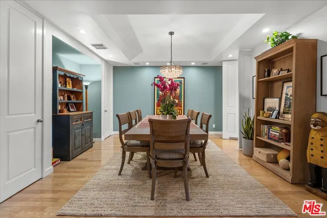 a dining room with furniture and wooden floor