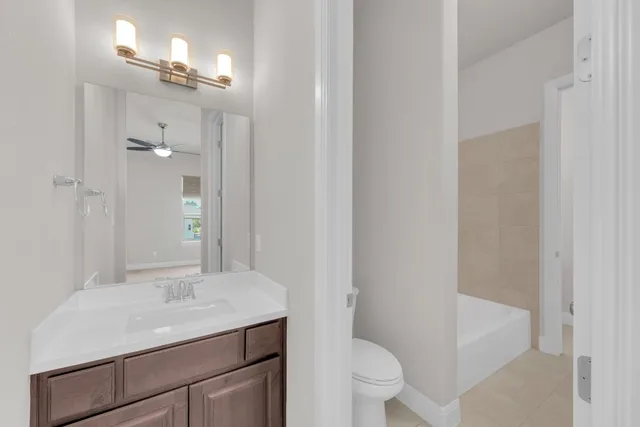 a bathroom with a sink toilet vanity and shower