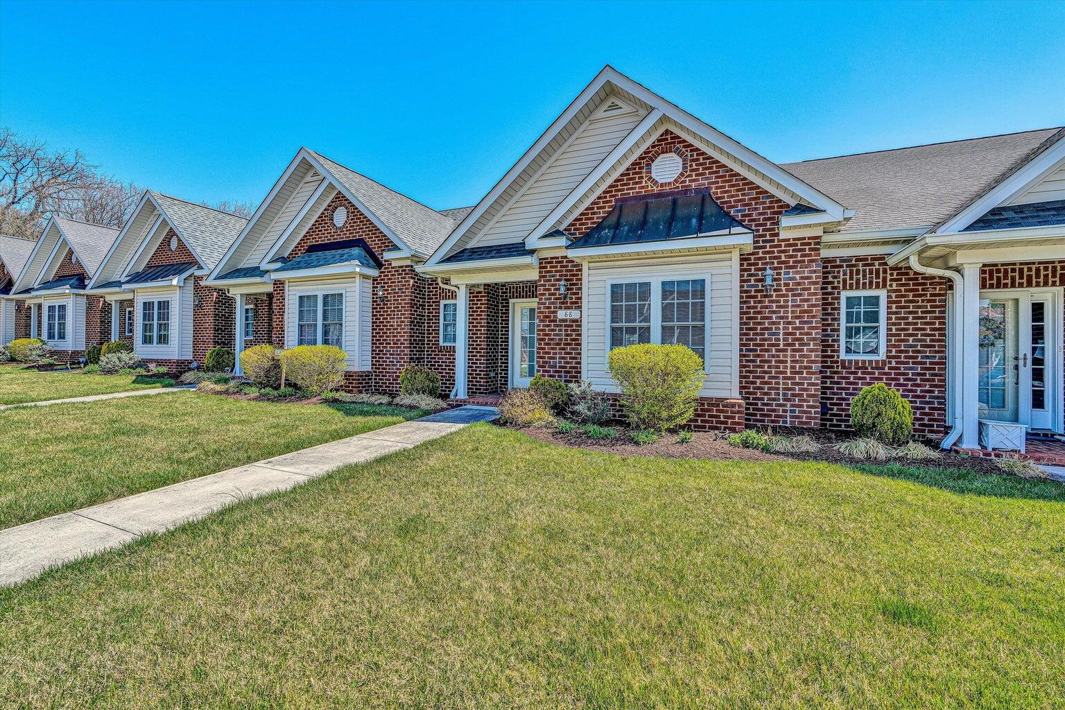a front view of a house with yard and green space