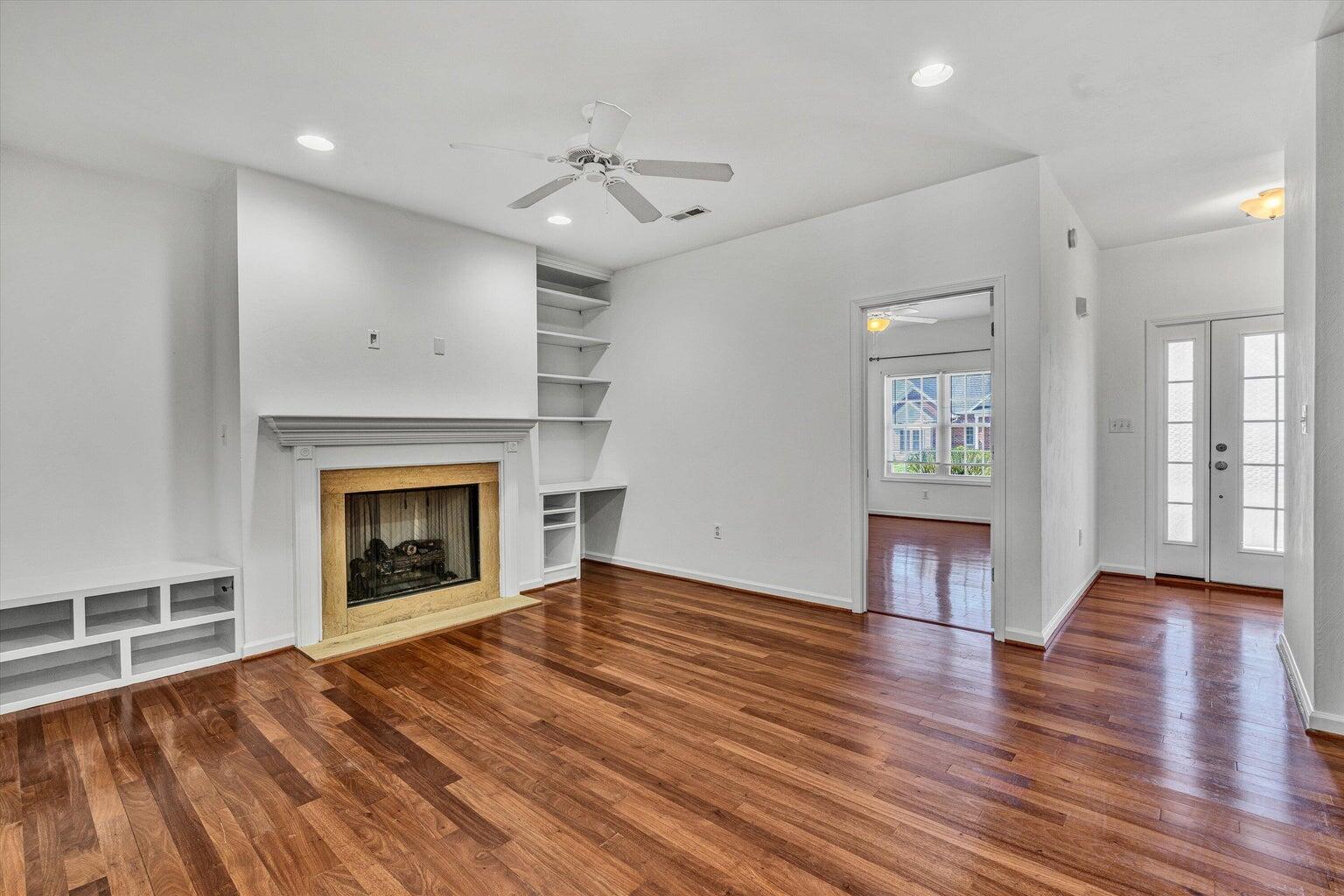 88 Maple Street Salem, VA 24153 - Photo 6 of 25 an empty room with wooden floor fireplace and windows