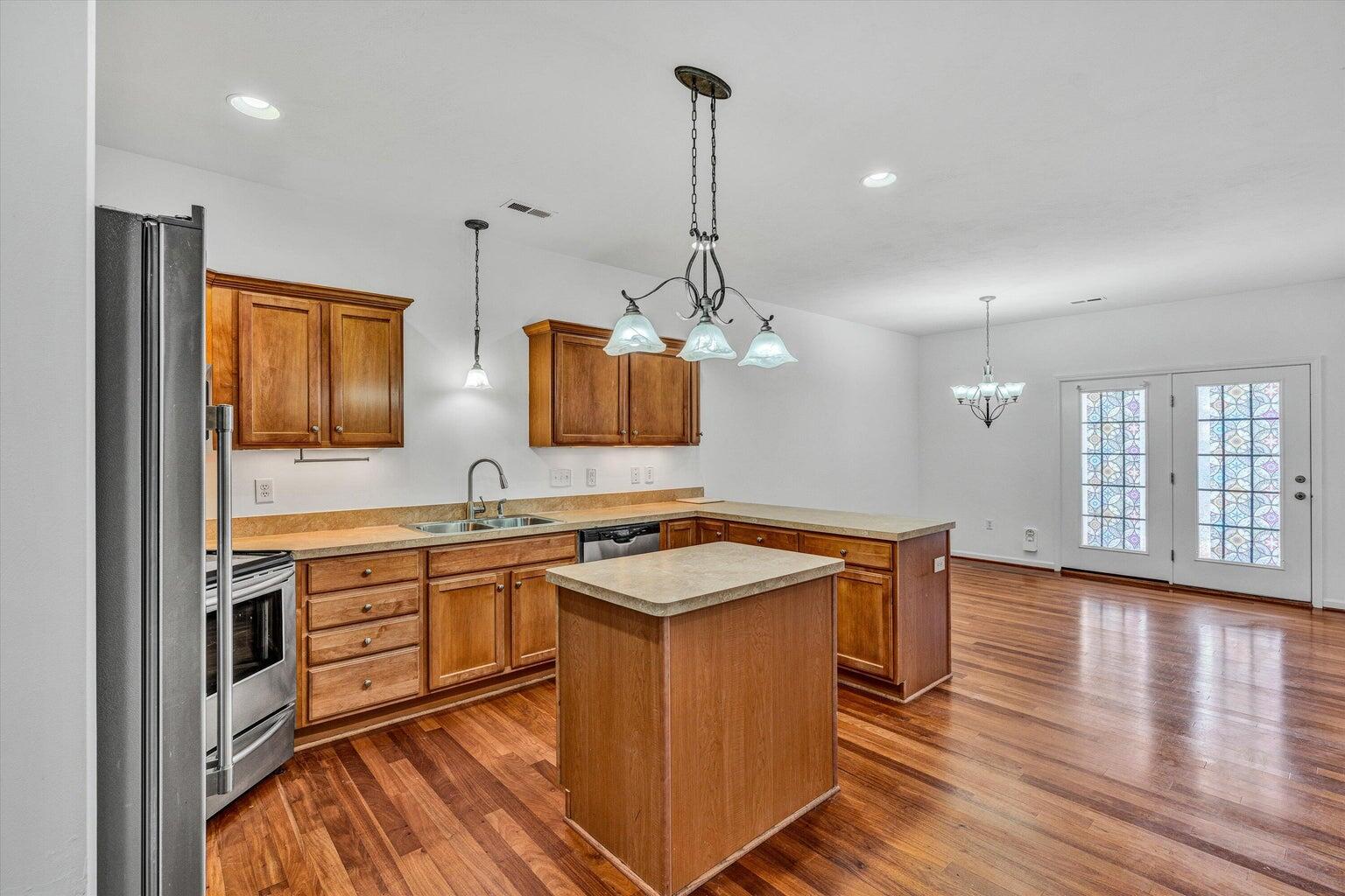 88 Maple Street Salem, VA 24153 - Photo 8 of 25 a kitchen with wooden cabinets and white appliances