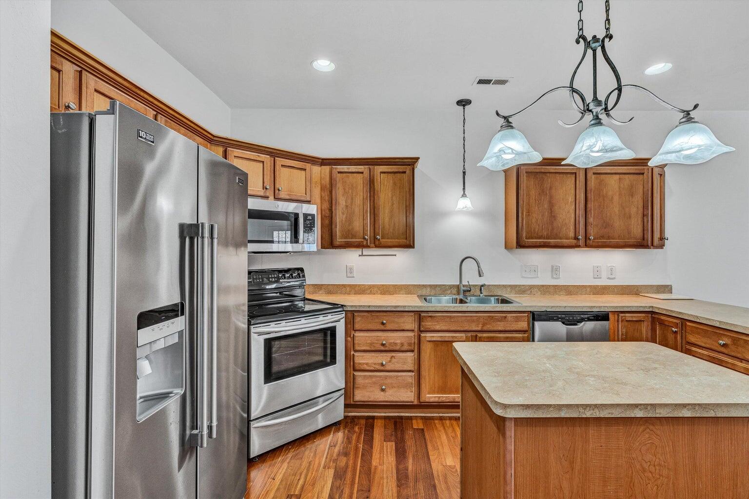 88 Maple Street Salem, VA 24153 - Photo 9 of 25 a kitchen with stainless steel appliances granite countertop a refrigerator a sink dishwasher a stove and white cabinets with wooden floor
