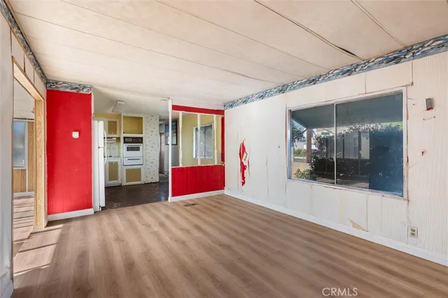 a view of a room with wooden floor and a large window