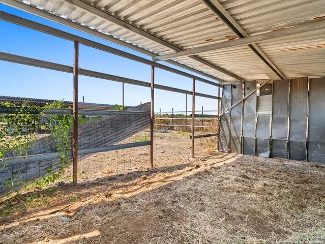 a green field with lots of trees in the background