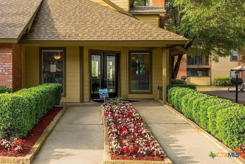2405 South 13th Street, Unit 721 Temple, TX 76504 - Photo 2 of 9 a view of a house with a large window and flower plants