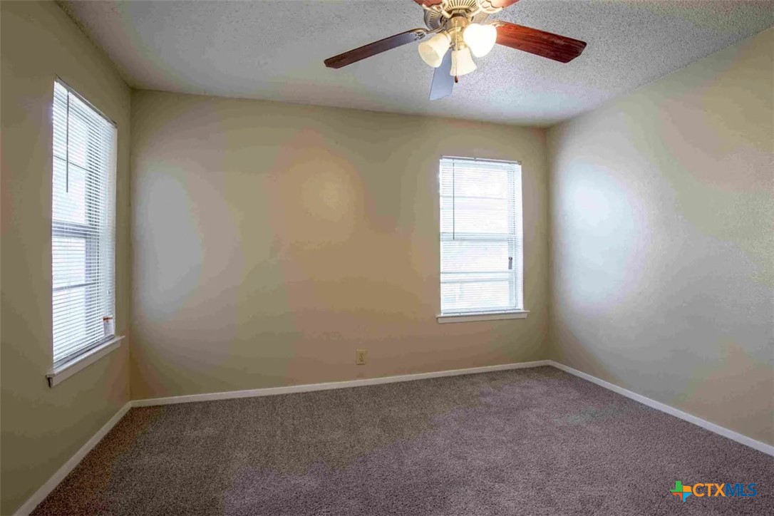 2405 South 13th Street, Unit 721 Temple, TX 76504 - Photo 6 of 9 an empty room with a window and a fan