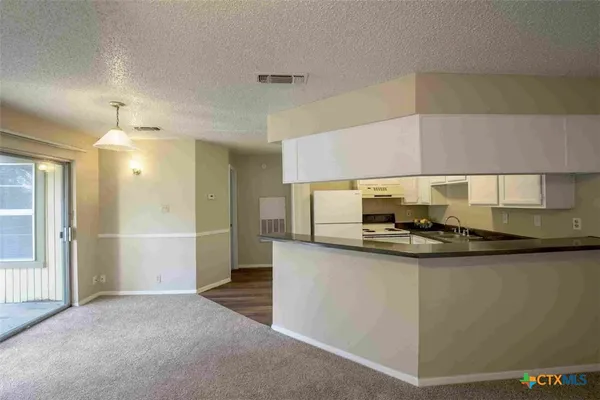 a kitchen with stainless steel appliances a sink stove and refrigerator