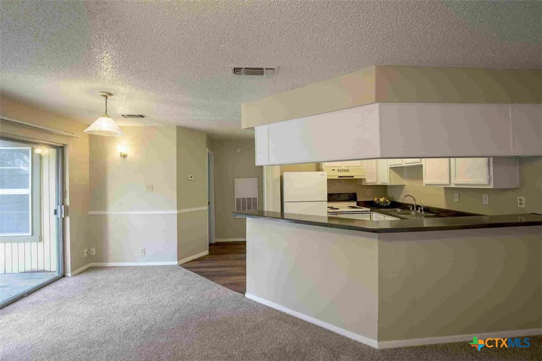 2405 South 13th Street, Unit 721 Temple, TX 76504 - Photo 8 of 9 a kitchen with stainless steel appliances a sink stove and refrigerator