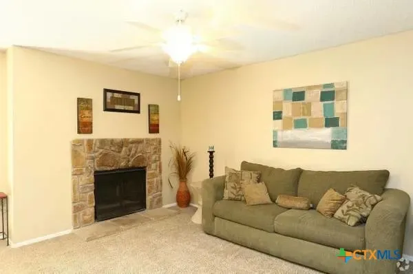 a living room with furniture and a fireplace