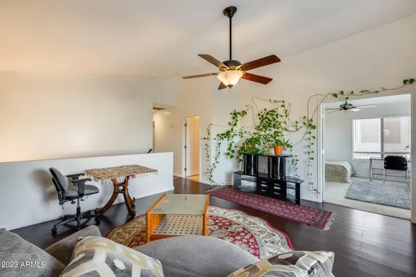 a living room with furniture and a chandelier