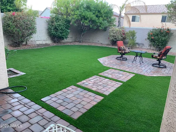 a view of a backyard with sitting area