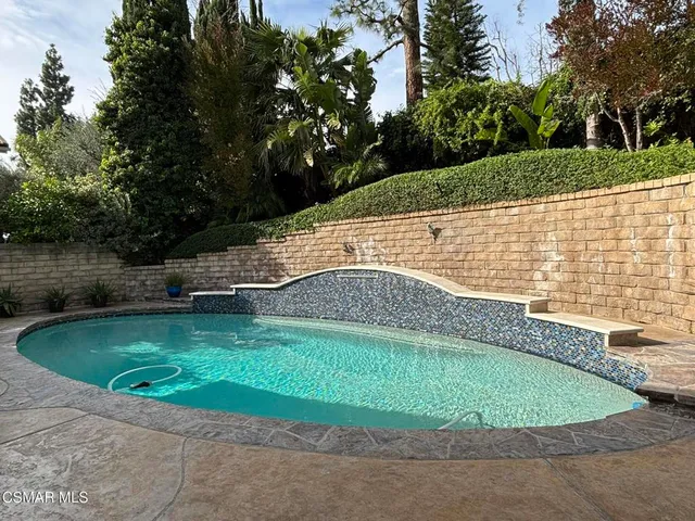a view of a swimming pool with a patio