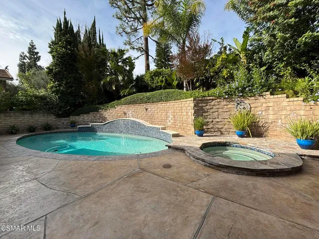 a view of a swimming pool with a yard