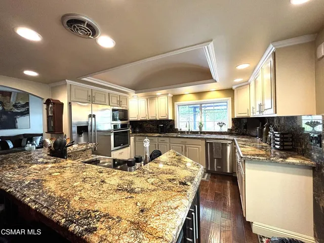 a kitchen with counter top space cabinets and appliances