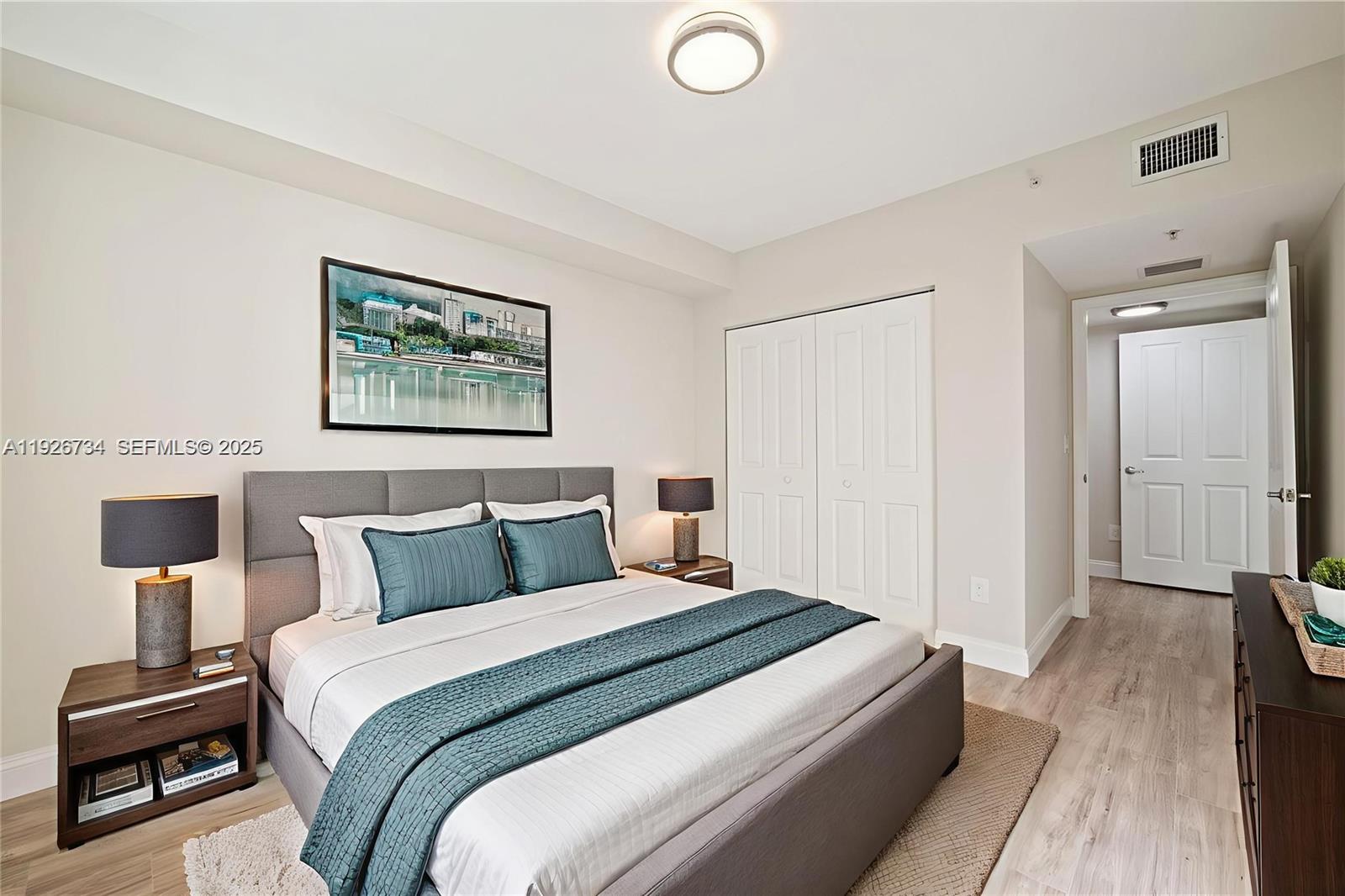 600 South Dixie Highway, Unit 237 West Palm Beach, FL 33401 - Photo 13 of 46 a bedroom with a bed and a painting on the wall