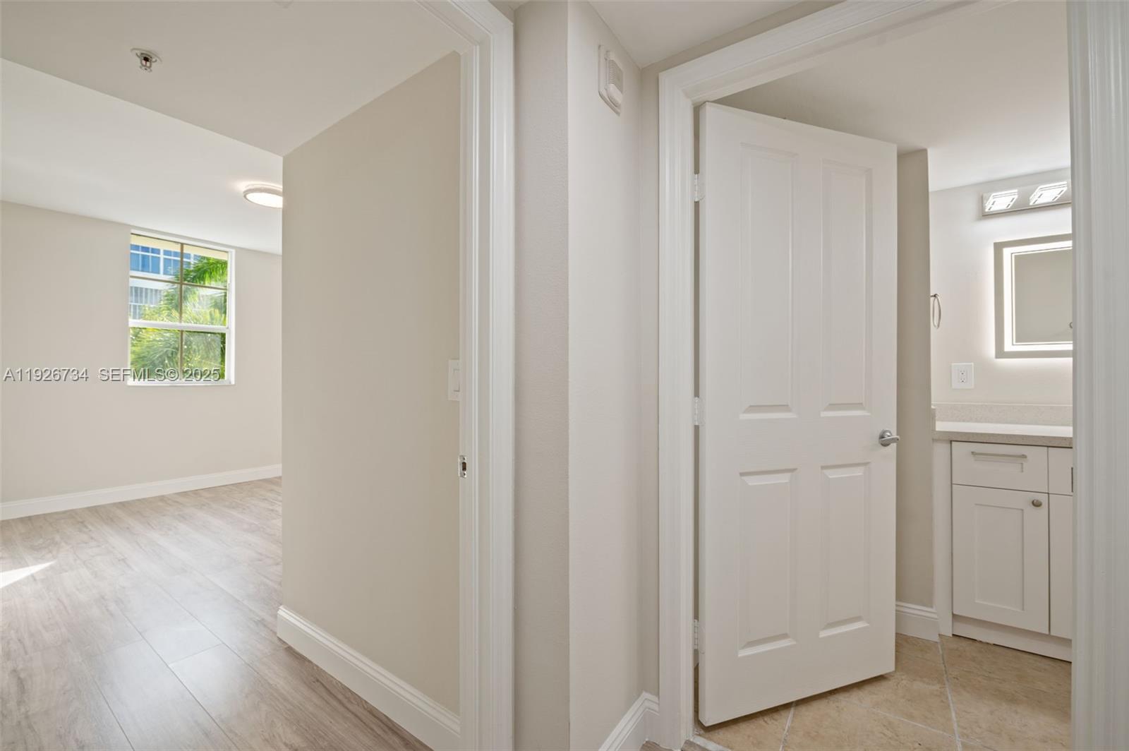 600 South Dixie Highway, Unit 237 West Palm Beach, FL 33401 - Photo 16 of 46 a view of an empty room with wooden floor and a window