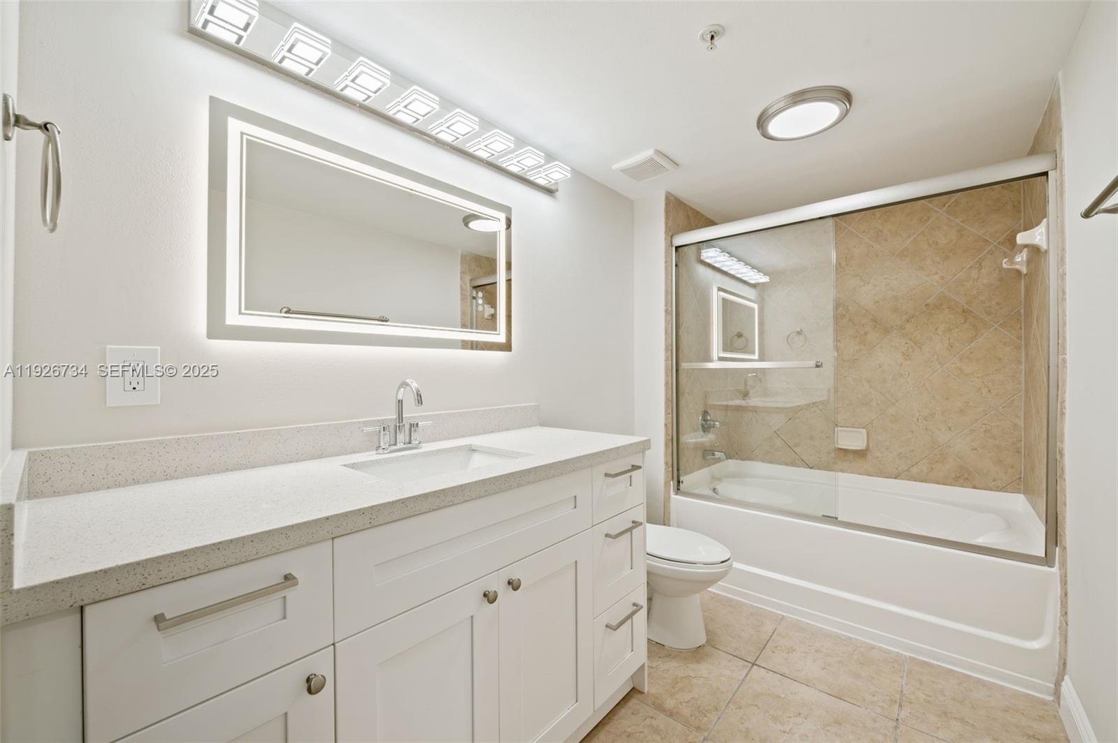 600 South Dixie Highway, Unit 237 West Palm Beach, FL 33401 - Photo 19 of 46 a bathroom with a granite countertop sink a toilet and a bathtub