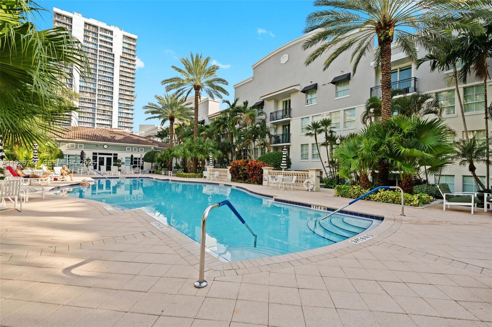 600 South Dixie Highway, Unit 237 West Palm Beach, FL 33401 - Photo 24 of 46 a swimming pool with outdoor seating and yard