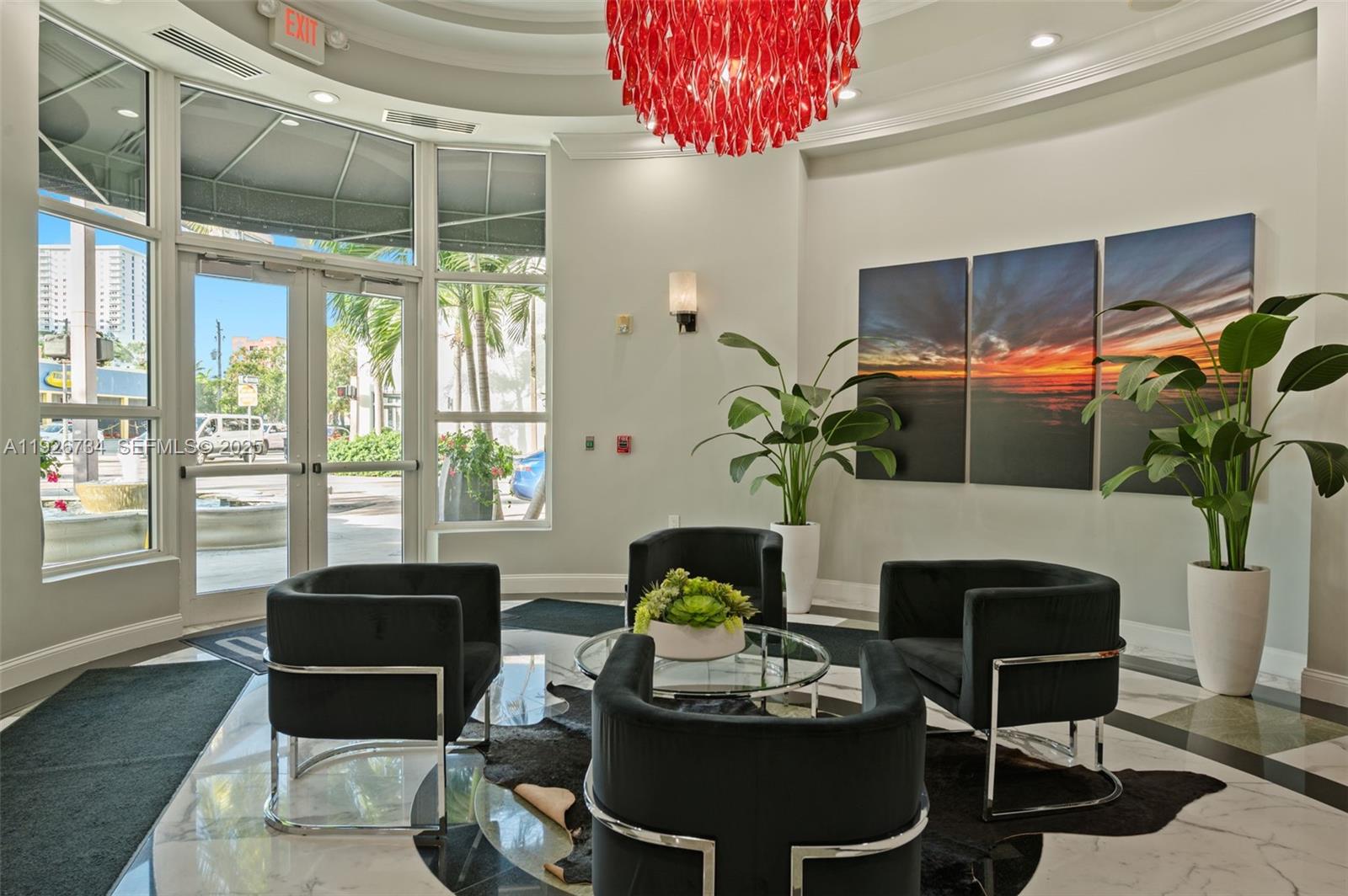 600 South Dixie Highway, Unit 237 West Palm Beach, FL 33401 - Photo 28 of 46 a living room with furniture a chandelier and a fireplace