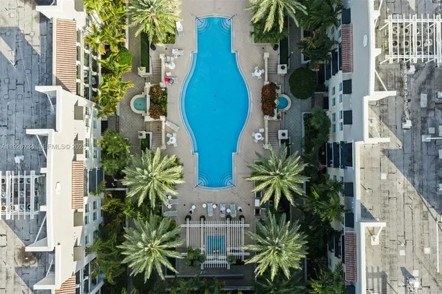 a kitchen with stainless steel appliances granite countertop a stove top oven a sink dishwasher a dining table and chairs with wooden floor