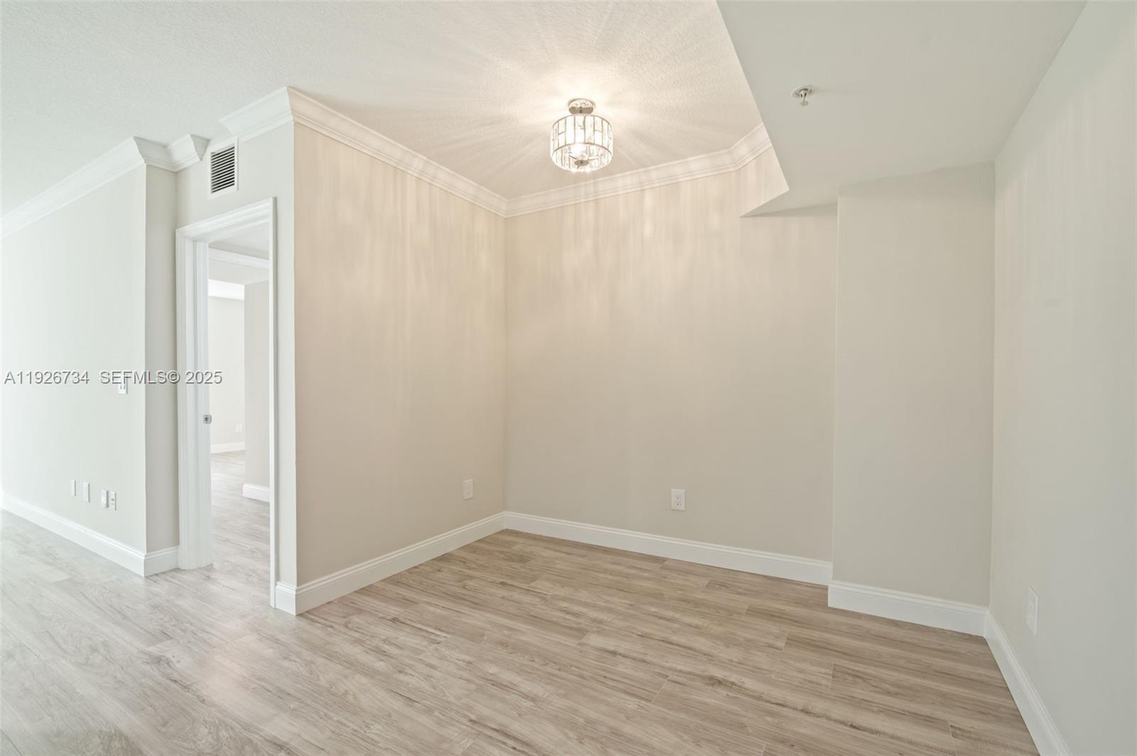 600 South Dixie Highway, Unit 237 West Palm Beach, FL 33401 - Photo 39 of 46 a view of an empty room with wooden floor and a bathroom