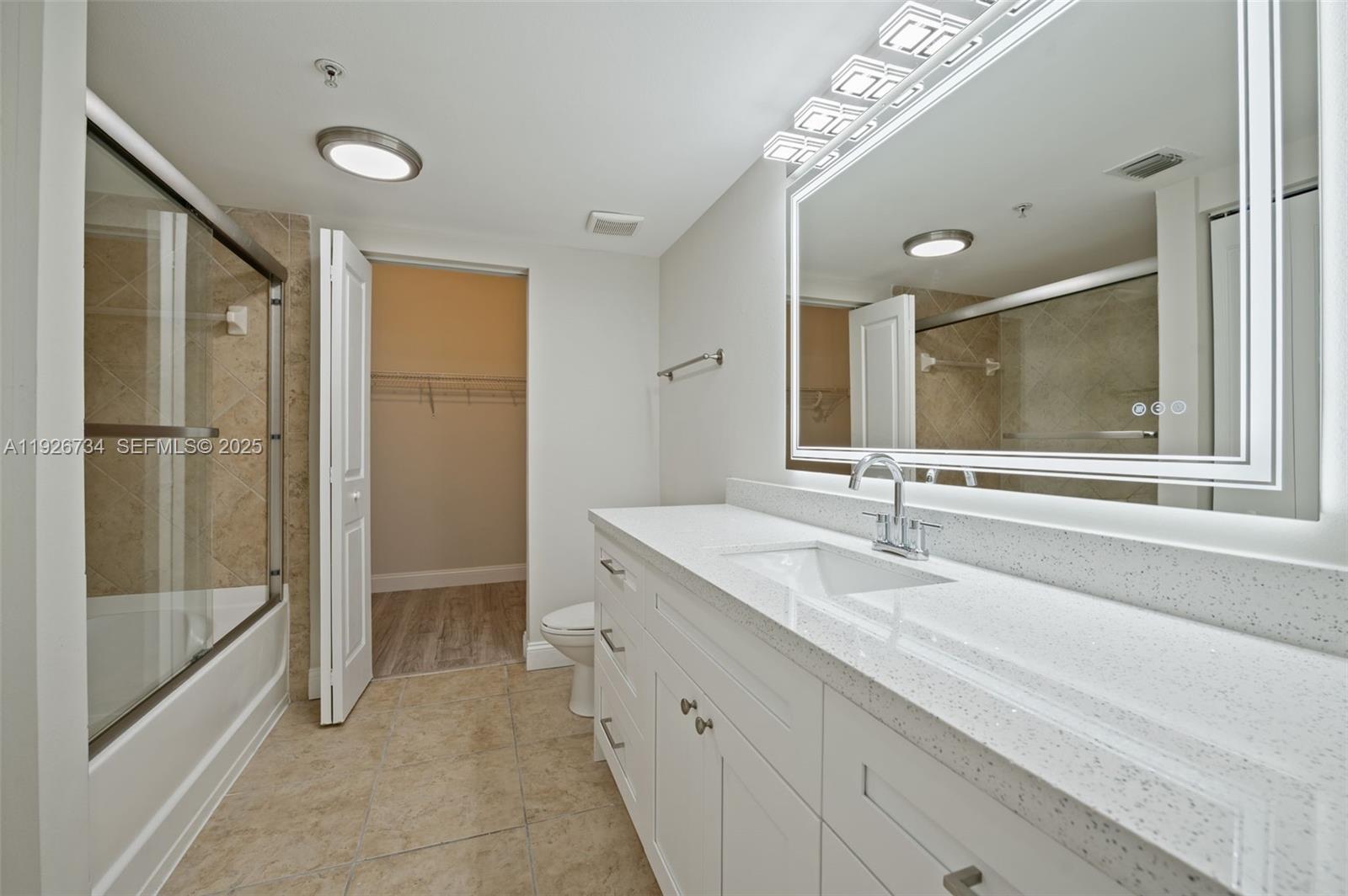 600 South Dixie Highway, Unit 237 West Palm Beach, FL 33401 - Photo 41 of 46 a spacious bathroom with a shower sink and mirror